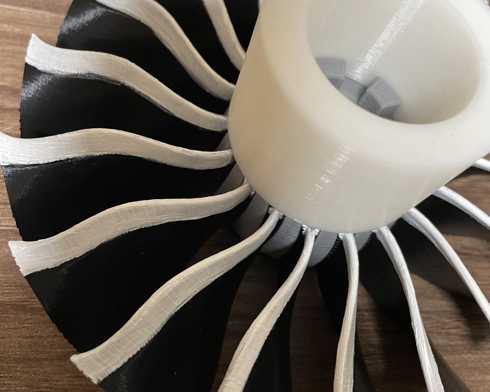 The assembled fan up close: black blades with white painted edges.