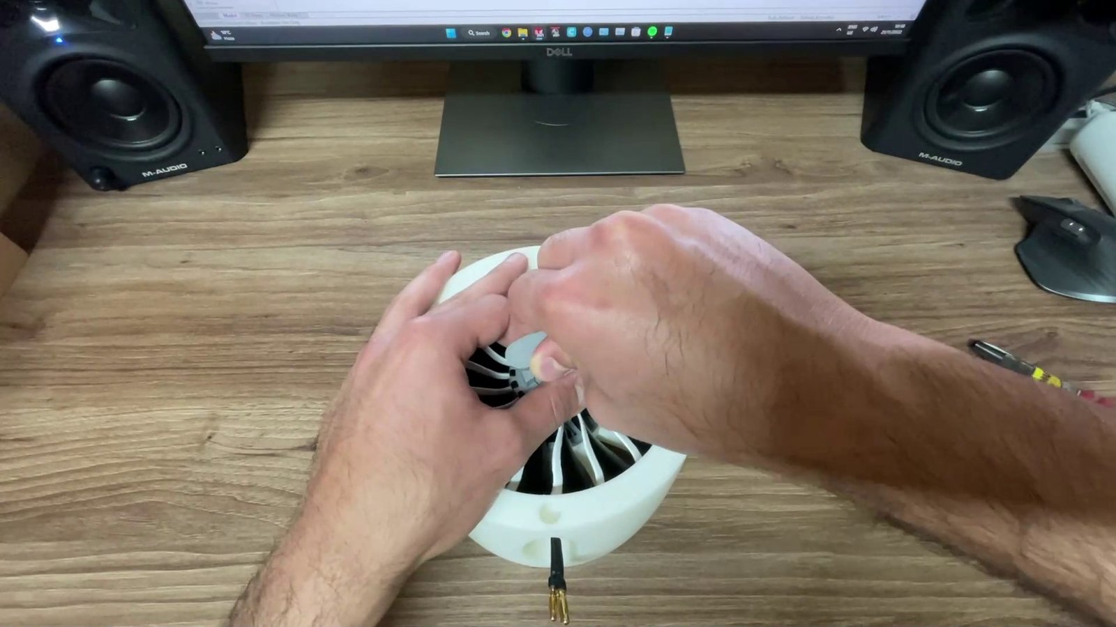 Fitting the fan into the main body on the desk.