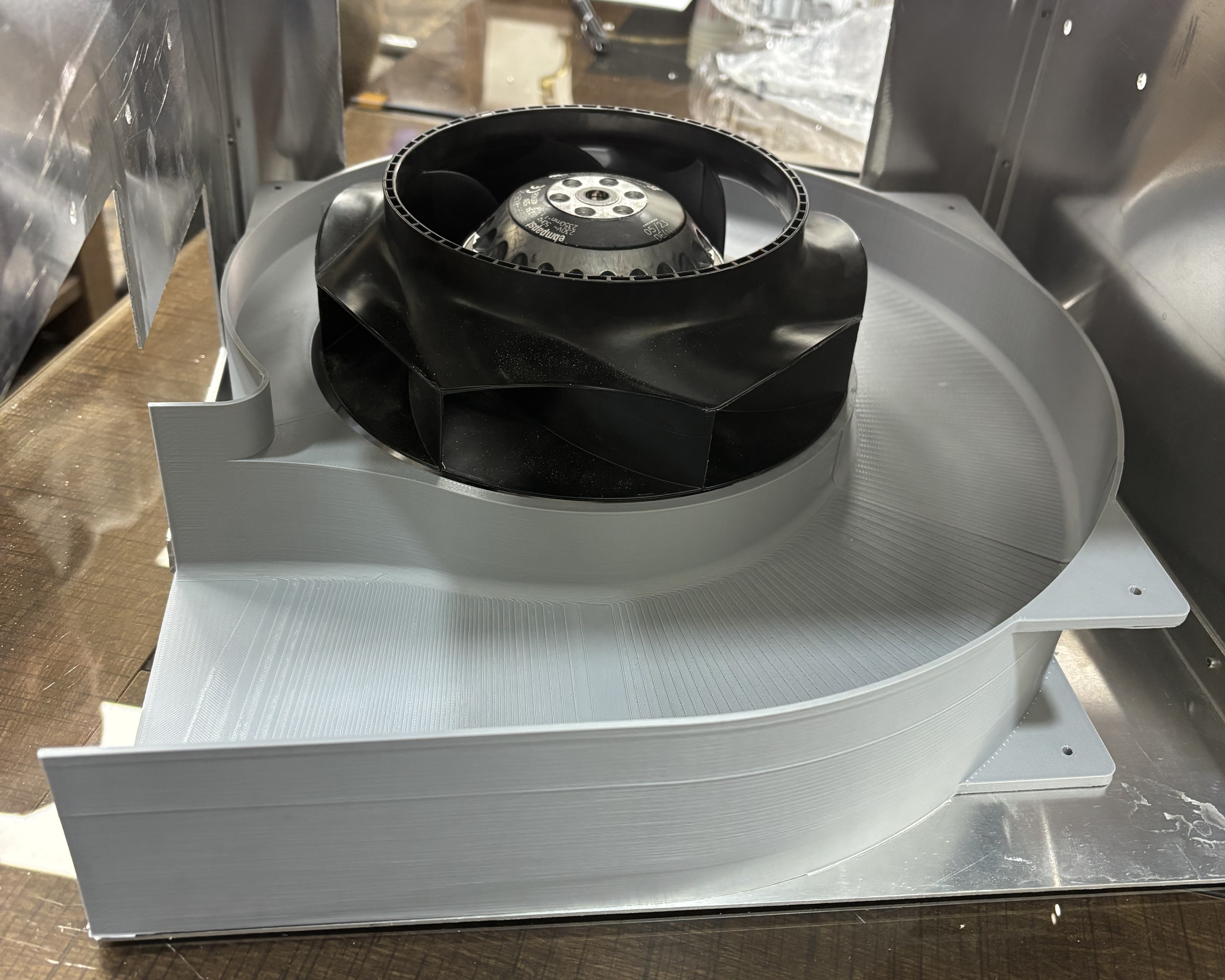 The fan seated in the printed scroll volute.
