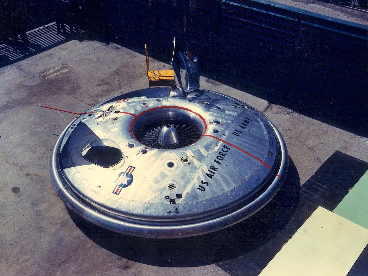 Colour photograph of the Avrocar from above, showing the central turborotor and the US Air Force and US Army markings on the disc.