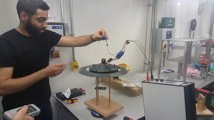 The assembled scale model mounted on its wooden test stand, set up for a lift run.