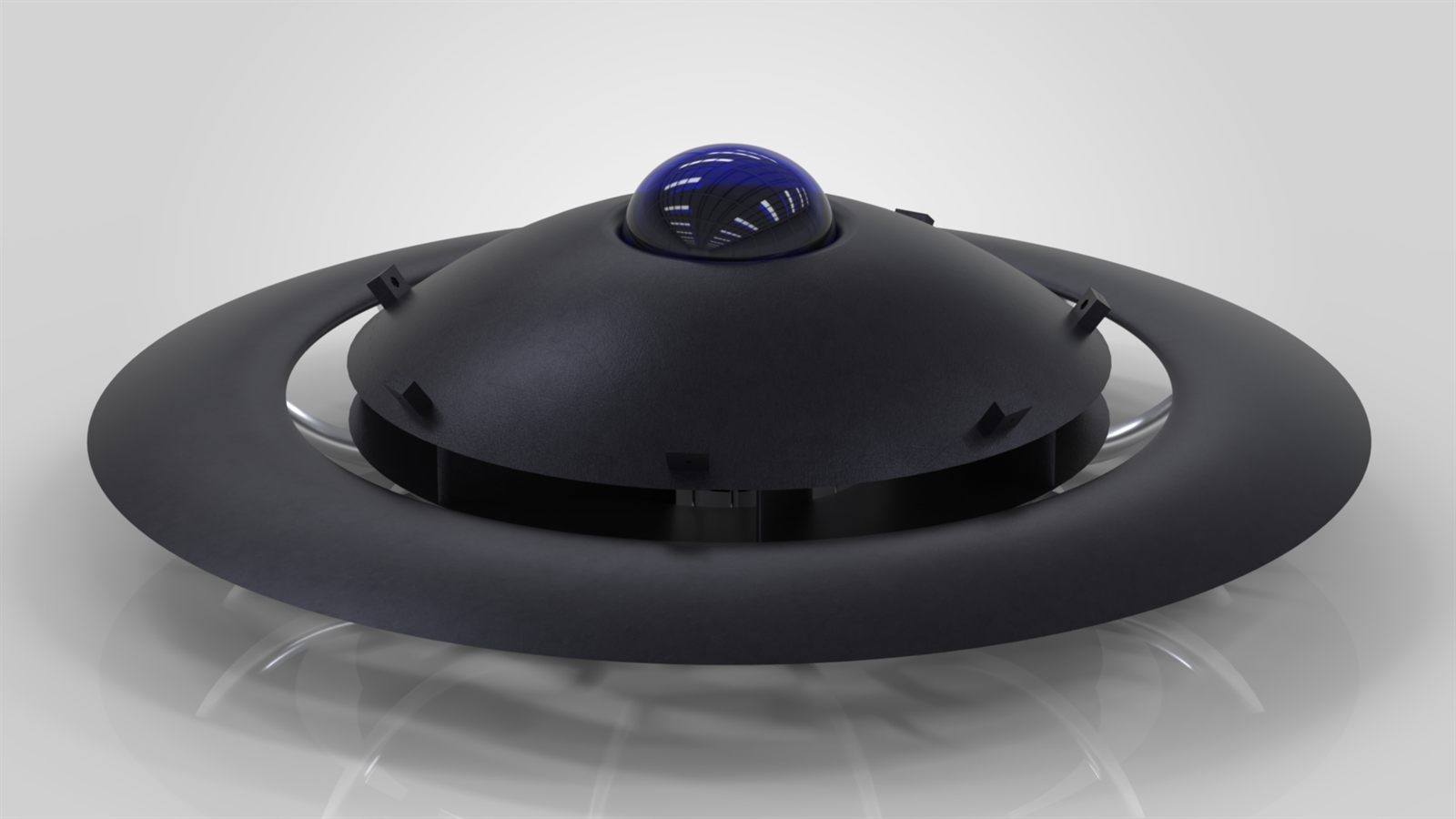 Three-quarter render of Project Saturn: a dark saucer body with a blue domed canopy and curved ducts around the rim, on a light studio background.